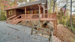A wooden cabin with a porch and steps leading up to it, surrounded by trees and a gravel path. - Picturesque Clayton Cabin w/ Mountain Views! (Clayton)
