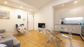 Design Apartment, City View | Living area | 40-inch flat-screen TV with digital channels