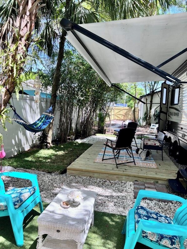 A patio area with outdoor furniture, a hammock, and a covered seating area.