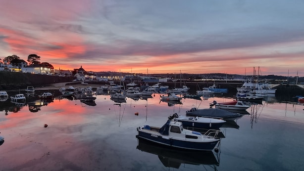 A marina with boats docked, calm water, and buildings in the background. - Rowcroft Lodge  (Paignton)