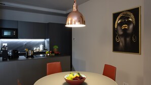 A modern kitchen with a dining area.