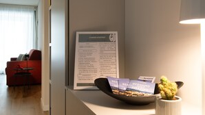 A reception desk with a welcome sign, a cactus, and a brochure.