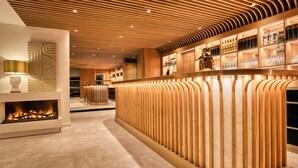 A modern bar area with a wooden ceiling and a central fire feature. - Das Kronberg - Adults Only (Bodenmais)