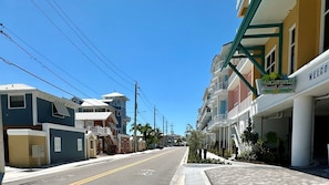 A street view of a coastal area with colorful buildings, including a hotel named 'Margaritaville Beach Resort' with a signboard. - Fins Right - Next to Margaritaville (Fort Myers Beach)