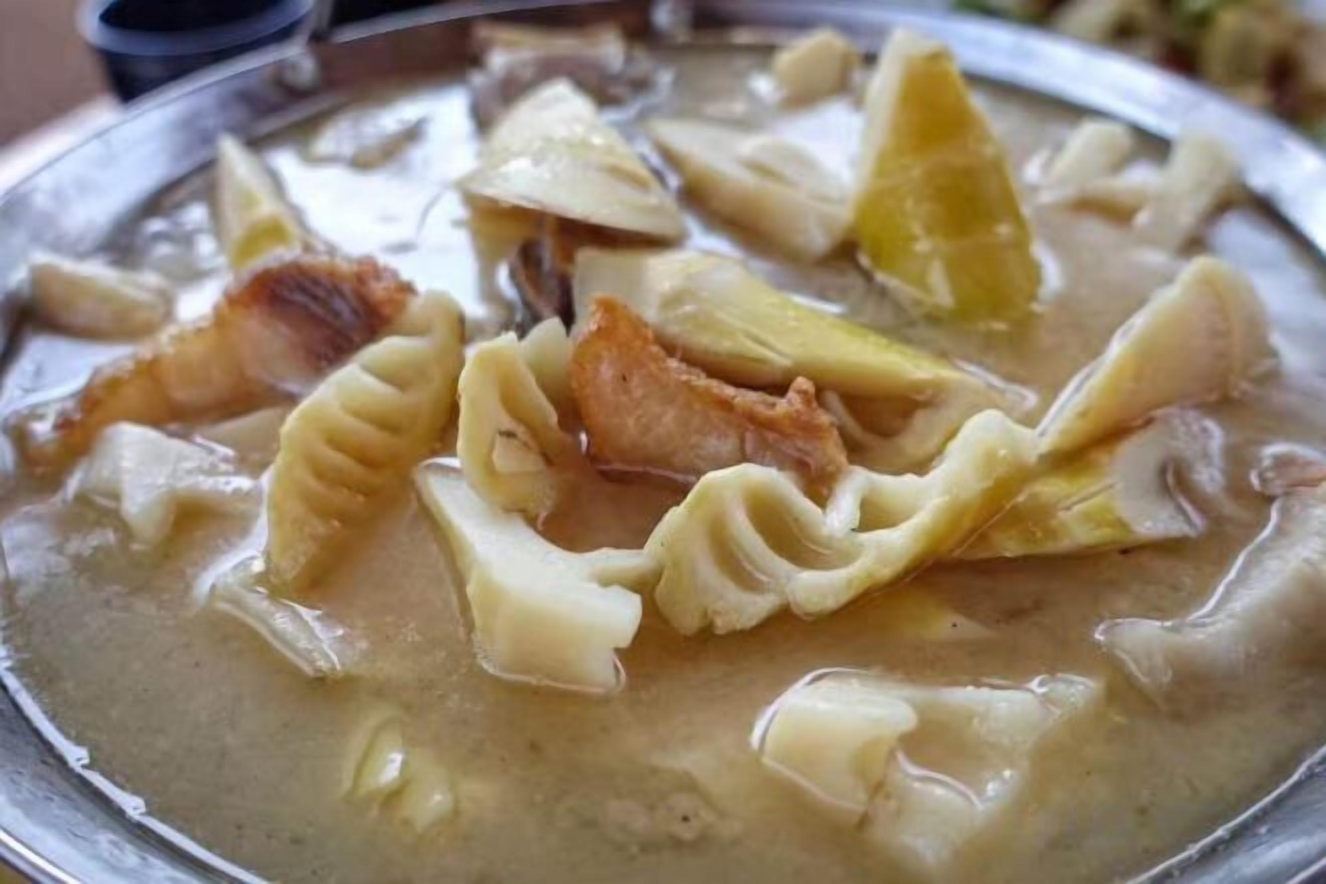A dish with pasta and bacon in a creamy sauce.