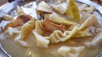 A dish with pasta and bacon in a creamy sauce.