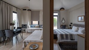 A modern hotel room with a dining area, a sofa, a bed, and a desk. - blue crystal view (Pangaio)