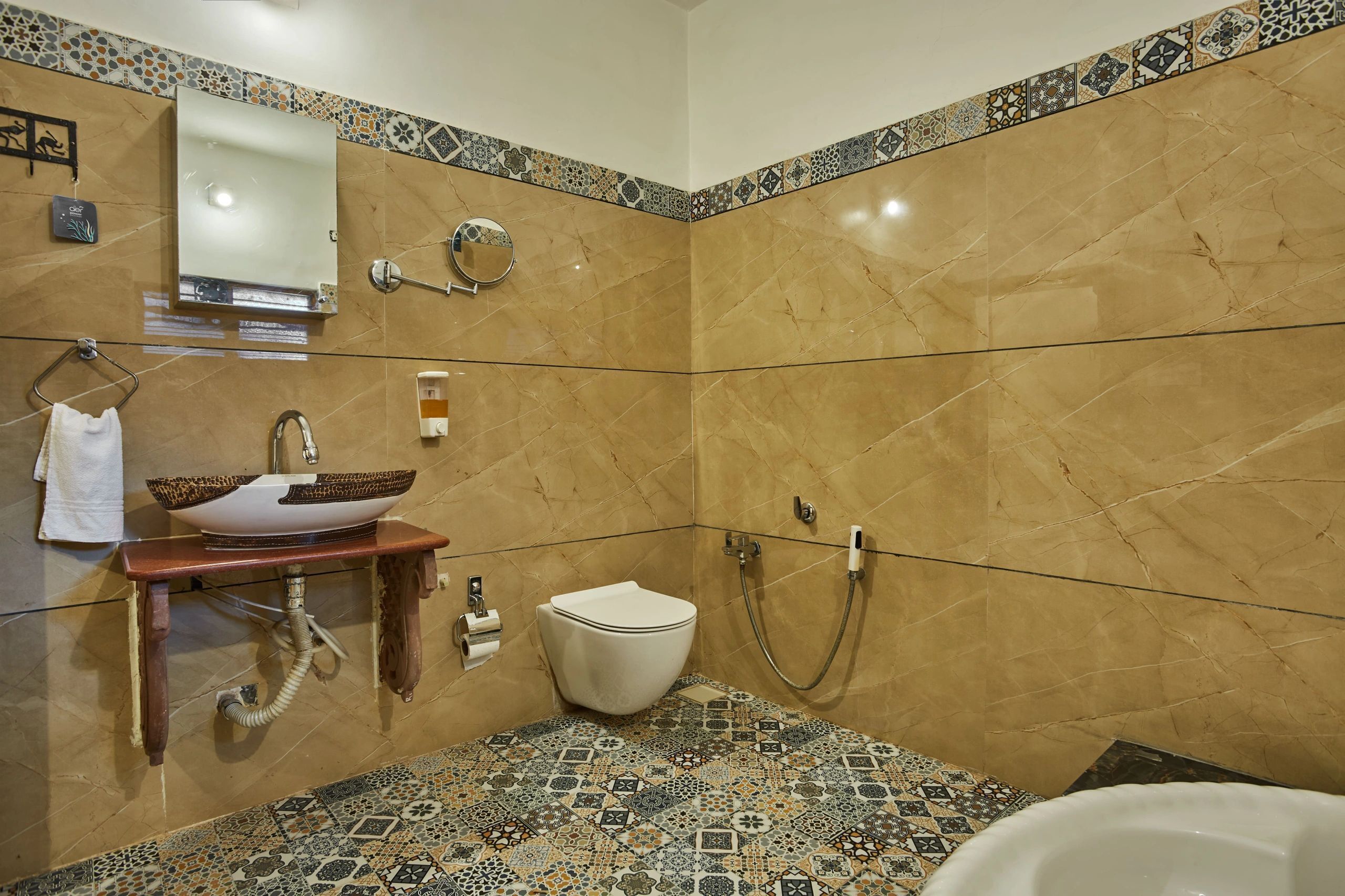 A bathroom with a marble sink, toilet, and shower.