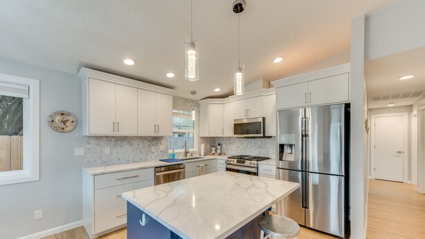 A modern kitchen with white cabinets, stainless steel appliances, a marble island, and pendant lighting. - Boise Retreat ~ 2 Mi to Boise State University! (Boise)
