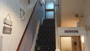 Eine Treppe mit einer Rezeption am oberen Ende.