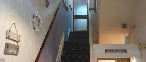 A staircase with a reception area at the top.