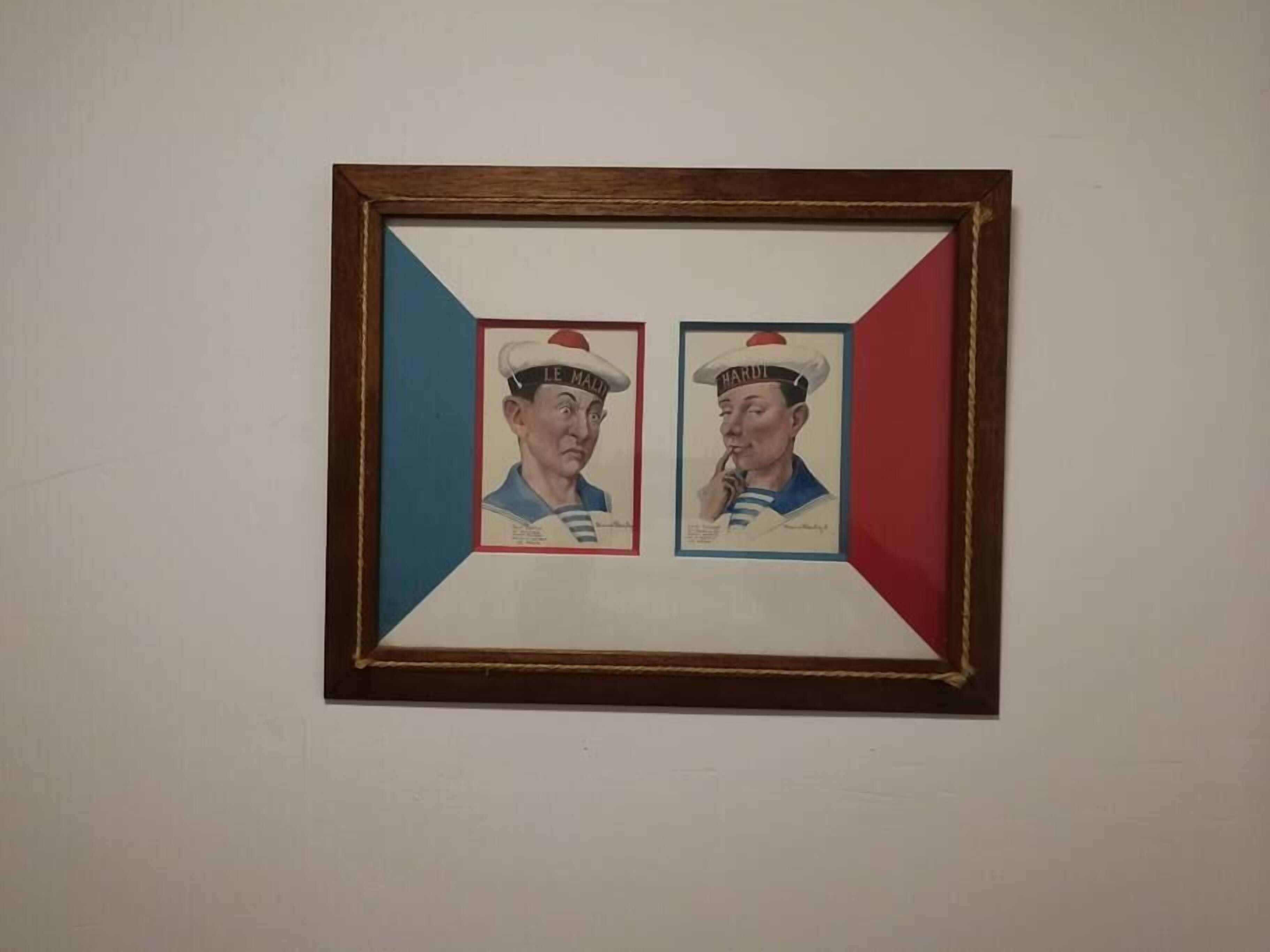 A framed artwork with two figures wearing sailor hats, one labeled "LE MAURIN" and the other "HARDI".