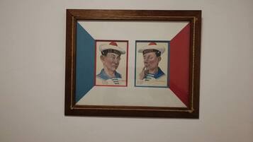 A framed artwork with two figures wearing sailor hats, one labeled "LE MAURIN" and the other "HARDI".