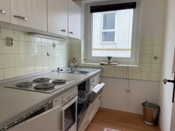 A kitchen with a Bosch stove, a dishwasher, and a window with a view.