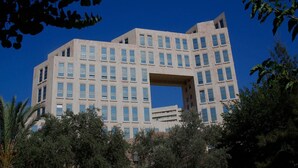 A modern building with a unique architectural design featuring a large central void.