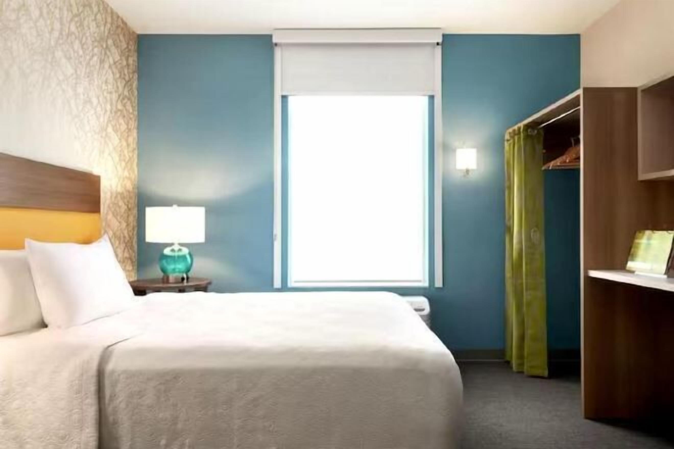 Premium bedding, desk, laptop workspace, iron/ironing board