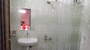 A bathroom with a shower, sink, and toilet. - Avexia Fun City Resort  (Mirzapur)