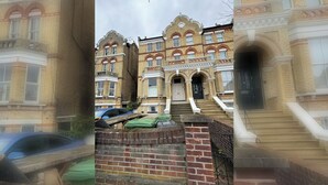 A multi-story building with a traditional architectural style, featuring a prominent entrance with steps and a door. - 2BDR Hidden Gem in the Heart of Clapham (London)