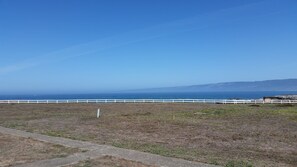 A coastal landscape with a white fence and a clear view of the ocean. - Point Arena Lighthouse - Assistant Keeper's House 3 (Point Arena)