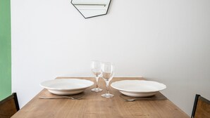 A dining table with two plates, two wine glasses, and two forks. - Central Part-Dieu - Apartment 1 (Lyon)