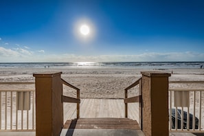 A wooden staircase leading to a beach with a clear sky and the sun shining. - Unobstructed Sunsets at Gulf Shores in Indian Shores 7th Floor 2/2 condo~ Gfs709 (Indian Shores)