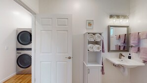 A bathroom with a white sink, a mirror, and a towel rack. - Lake & Vineyard View (Pulteney)