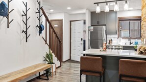 A modern kitchen with a central island, stainless steel appliances, and pendant lighting. - Prime Location on Camelback Mtn, Renovated w/ Movie & Game Room The Bear's Den (Tannersville)