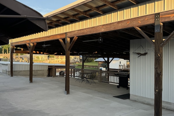 Outdoor covered patio area with grill