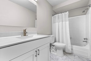 Shower, hair dryer, towels, shampoo