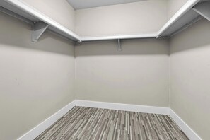A corner room with a wooden floor, white walls, and a white ceiling. - The Best Stay with Parking and Amenities! (Rochester Hills)