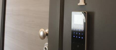 A door with a digital lock and a number plate indicating room 1.