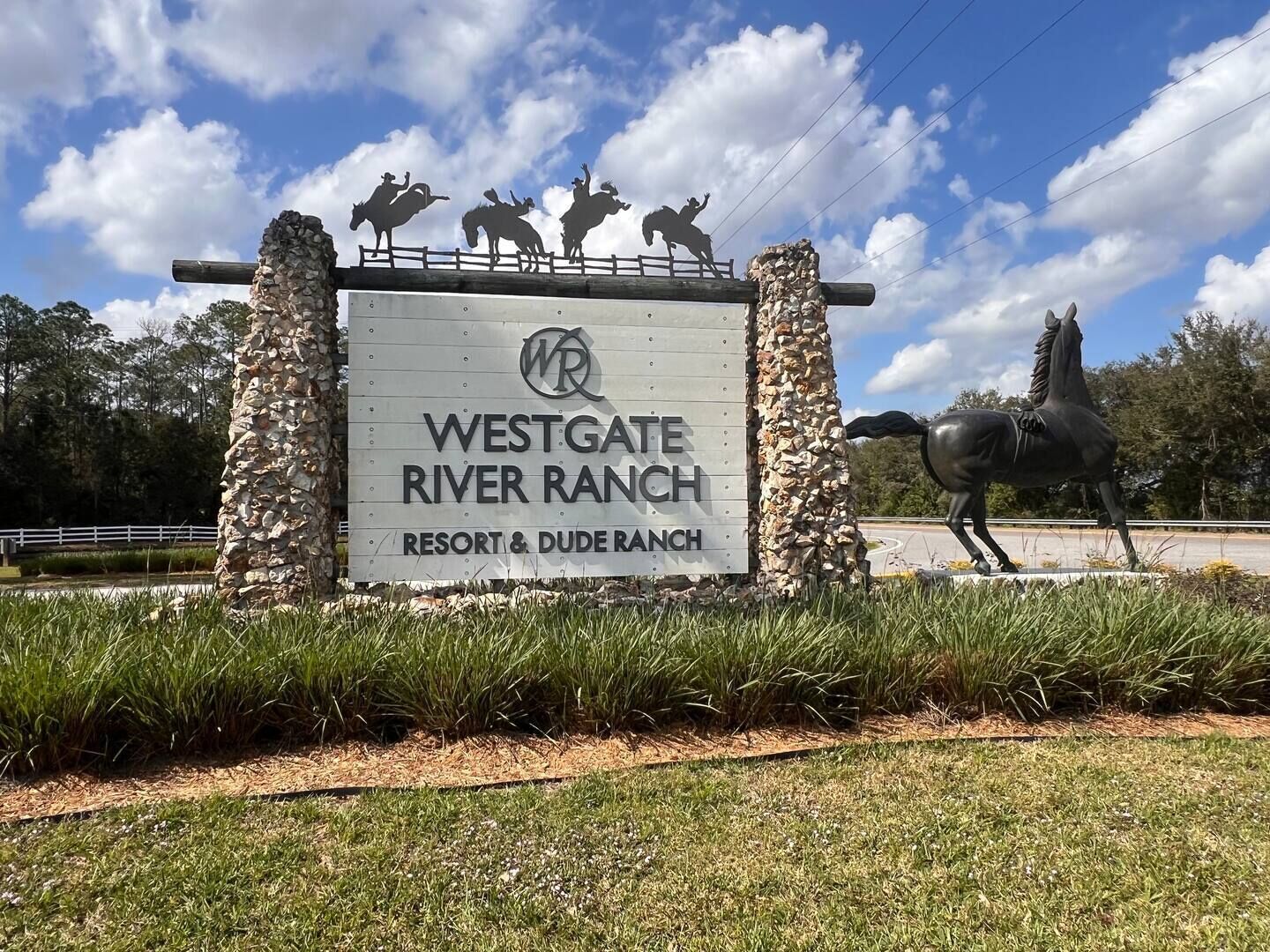 A sign for Westgate River Ranch with a logo and the name of the resort.