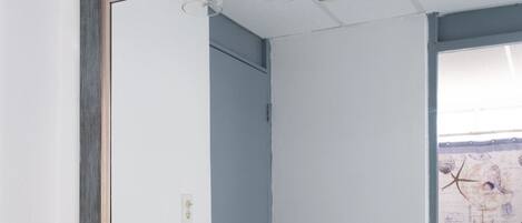 A bathroom with two sinks, a large mirror, and a light fixture above the mirror.