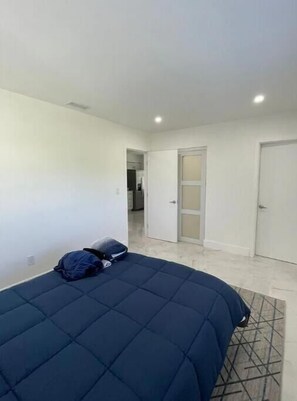 Cozy retreat with a large bed and clean, minimalist design.