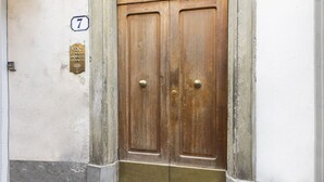A wooden double door with a brass knock plate and a number '7' sign. - Charming View apartment by Mmega (Firenze)