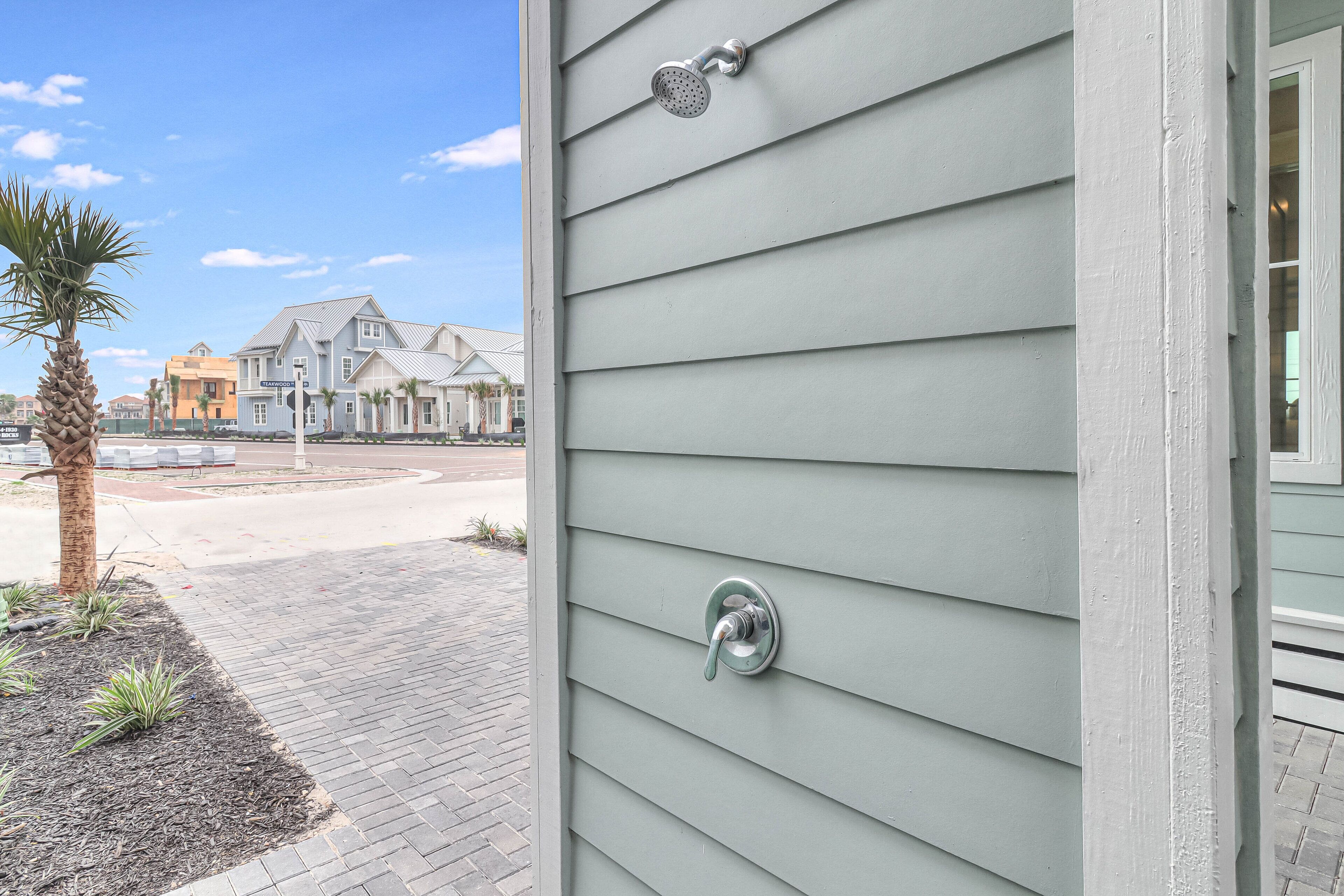 A house with a metal door handle and a window with a metal screen.