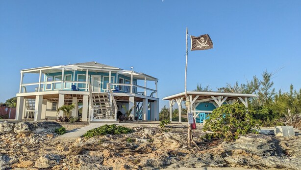 A two-story building with a balcony and a lifeguard station. - Aqua de Vista - Beachfront Villa w/ Stunning Sea Views in Central Abaco, BS (Joe's Creek)