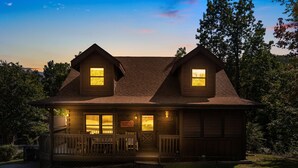 A two-story wooden house with a porch and two dormer windows. - ER81 - Family Making Memories (Pigeon Forge)