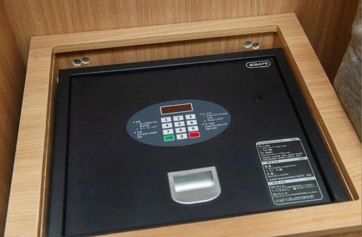 A JCSAFE electronic lock with a keypad and a card slot, installed in a wooden drawer.
