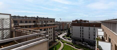 A residential area with multiple apartment buildings, a playground, and a road with cars.