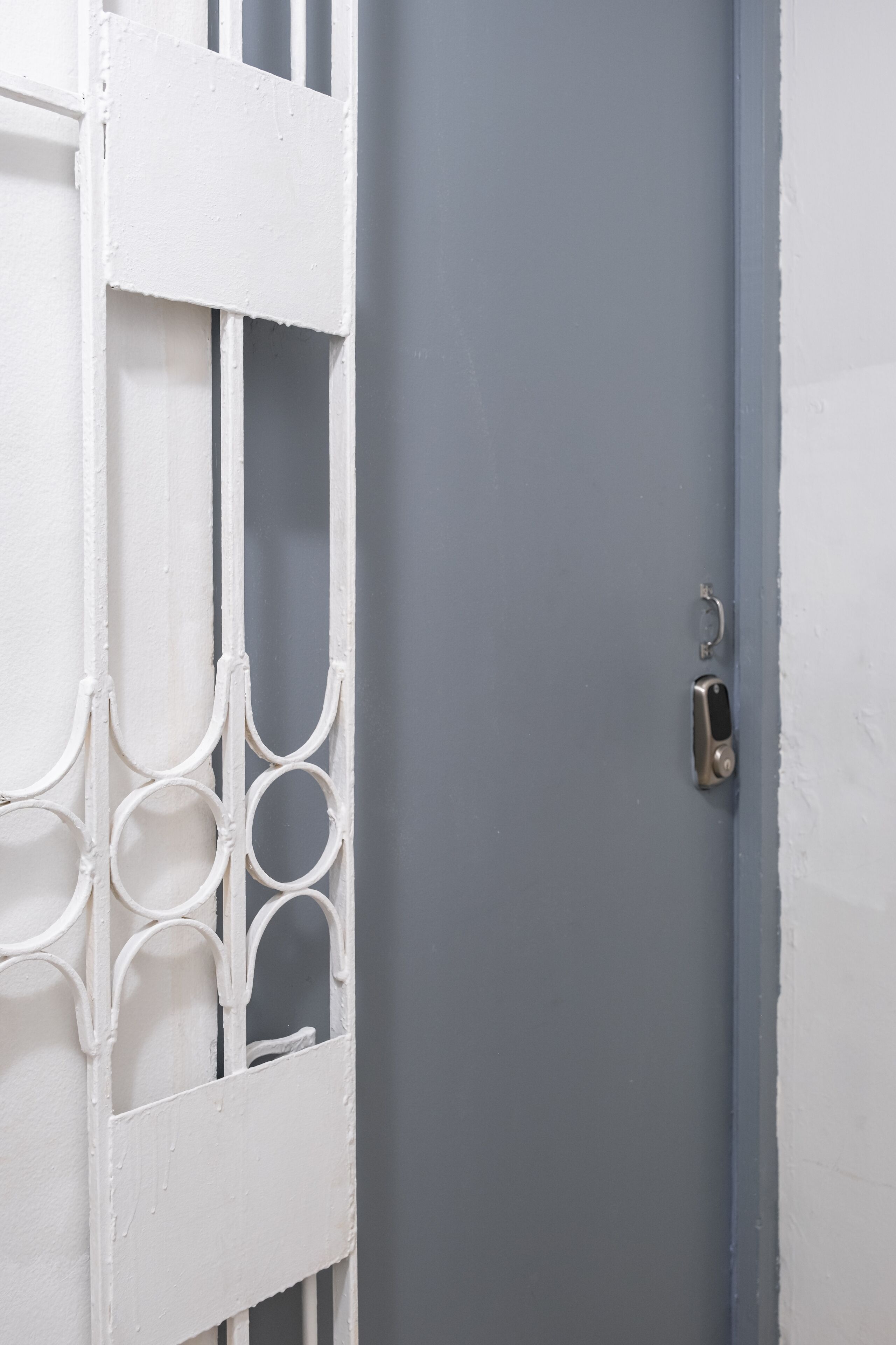 A white door with a metal handle and a keyhole.