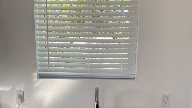 A kitchen with a stainless steel sink, a window with blinds, and a marble countertop. - Quiet studio 10 minutes from the beach!  (Torrance)
