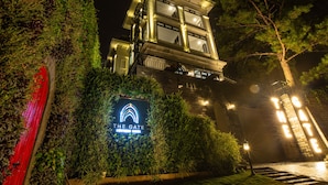 A hotel with a sign reading "The Gate" surrounded by greenery. - The Gate Boutique Hotel Da Lat (Xuan Huong - Da Lat)
