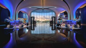 A luxurious lobby with a reflective floor, modern seating, and a large window offering a city view. - MGM Shenzhen (Shenzhen)