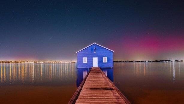 A blue building with a dock leading to it, surrounded by calm water and a night sky. - Mounts Bay Stay Two Bedroom Apt.   Near Kings Park - Free Parking - Wi-Fi (Perth)