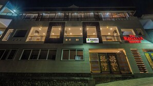 A hotel with a modern facade, multiple balconies, and a sign for 'The Regalia Rooms'. - Treebo The Regalia Rooms With Mountain View (Kodaikanal)