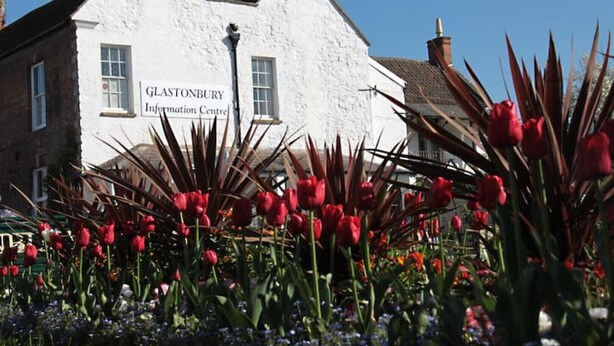 A white building with the sign "Glastonbury Information Centre".
