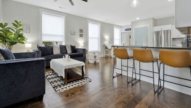 A modern kitchen with a central island, bar stools, and a ceiling fan. - *Sleeps 4* Downtown USA ~ Walkable Dickson Apt (Dickson)