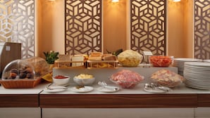A buffet setup with various food items and serving utensils. - Nagarjun Resort (Tarakeshwar)