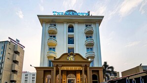 A hotel named "The Crown" with a classical facade, multiple balconies, and a prominent entrance. - Hotel S Crown Somnath  (Veraval)